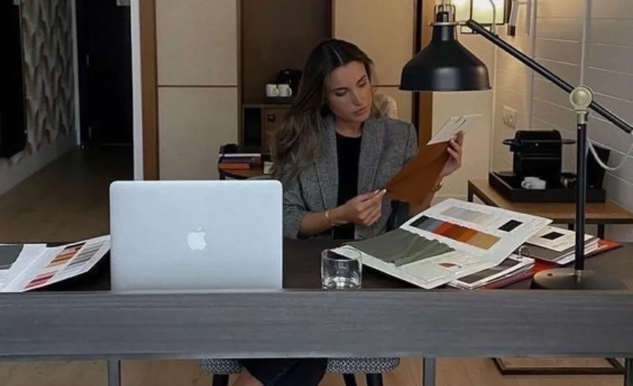 Woman at desk analyzing AI job security risk 2026
