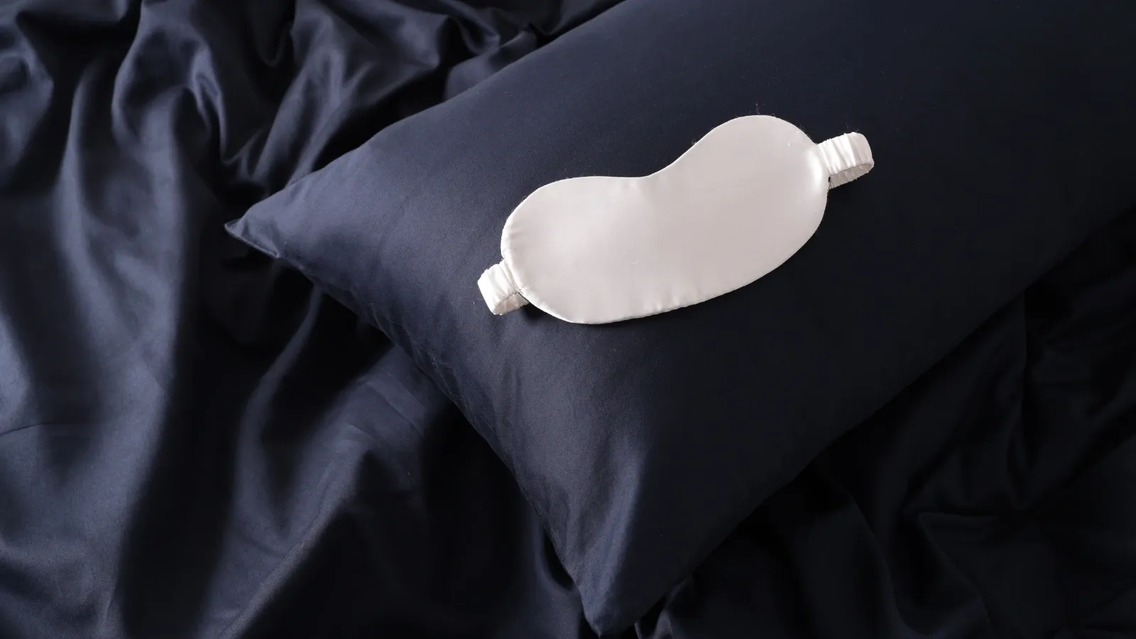 silk pillowcase with silk sheets and a silk eye mask