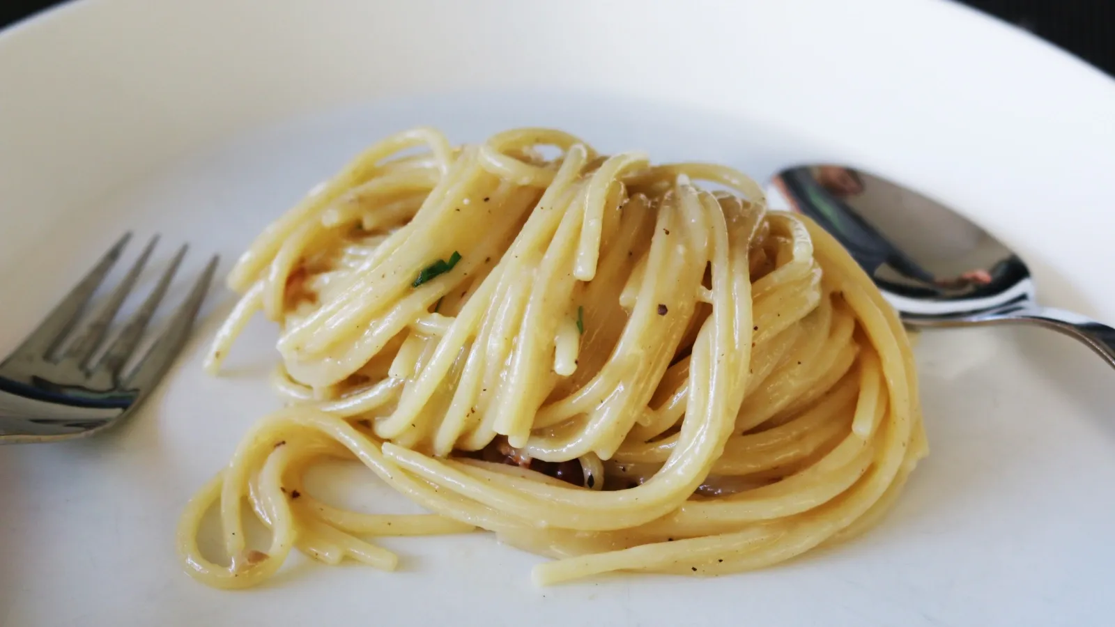 freshly made pasta dish with spoon and fork
