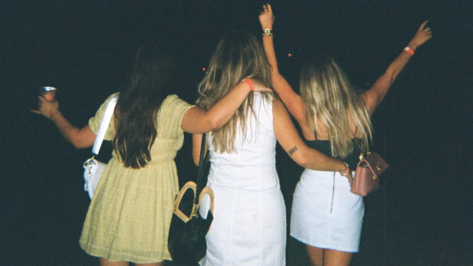 three women walking at night