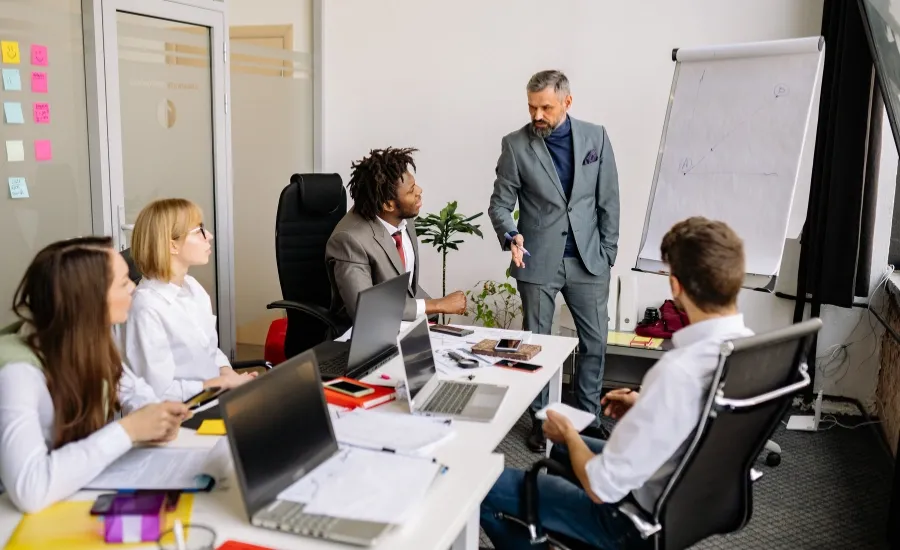 executive meeting with person presenting to colleagues