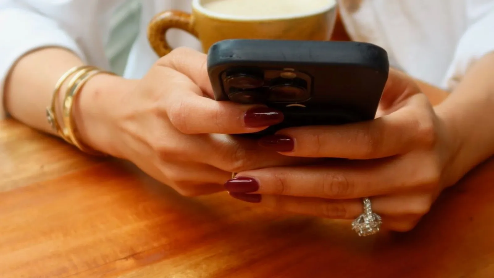 a woman holding her phone in her hands texting