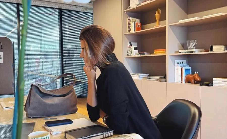 woman sitting in her desk and thinking