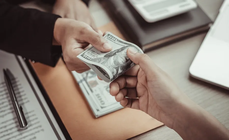 a man giving money to a another person